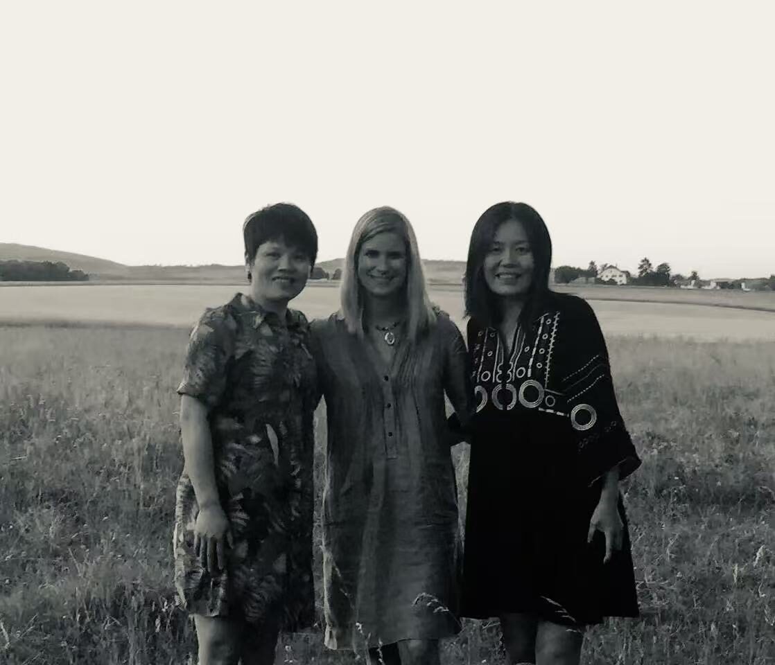 Three founders together in a field, black and white